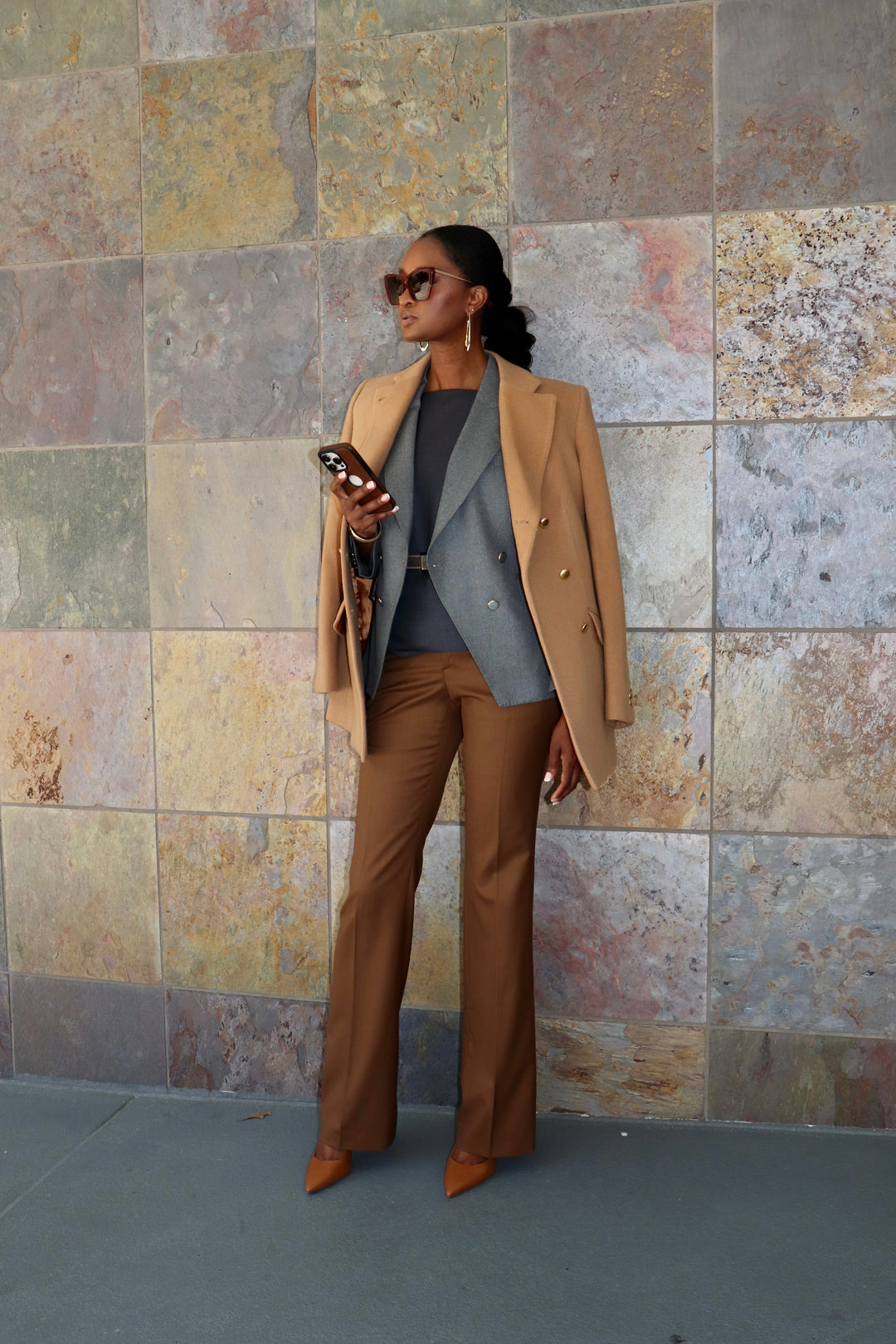Modern Grey DB Blazer with Cognac Flare Trouser, Charcoal Bateau Neck Top, Gold belt and Camel Carcoat.